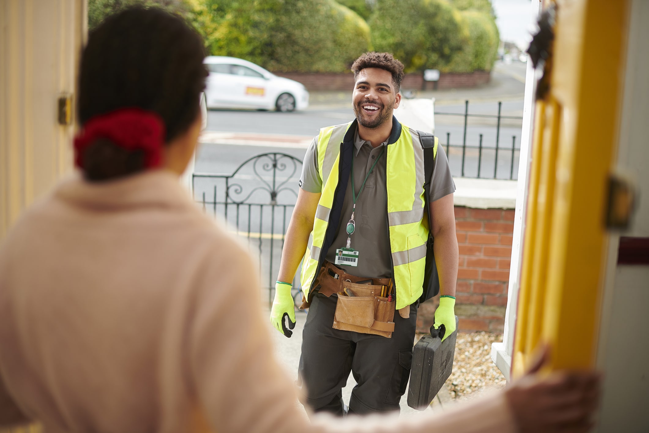 customer greeting tradesman at door